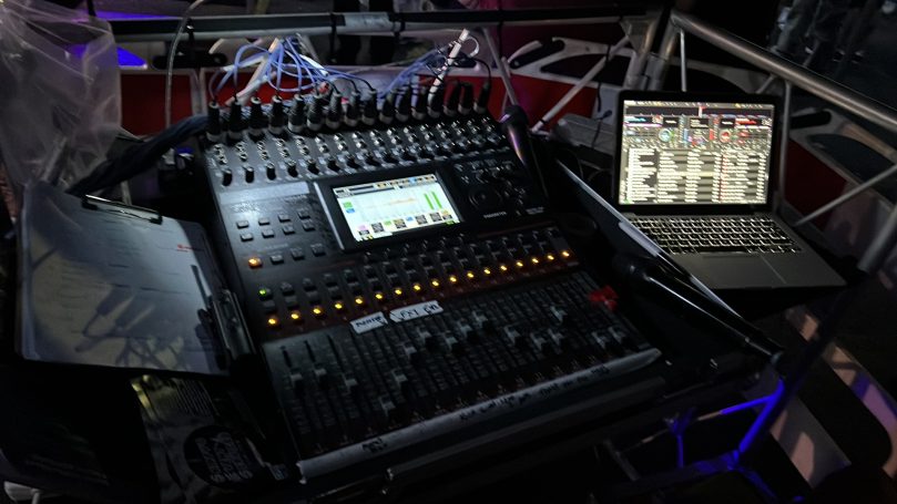 A digital audio mixer and a laptop displaying sound editing software.